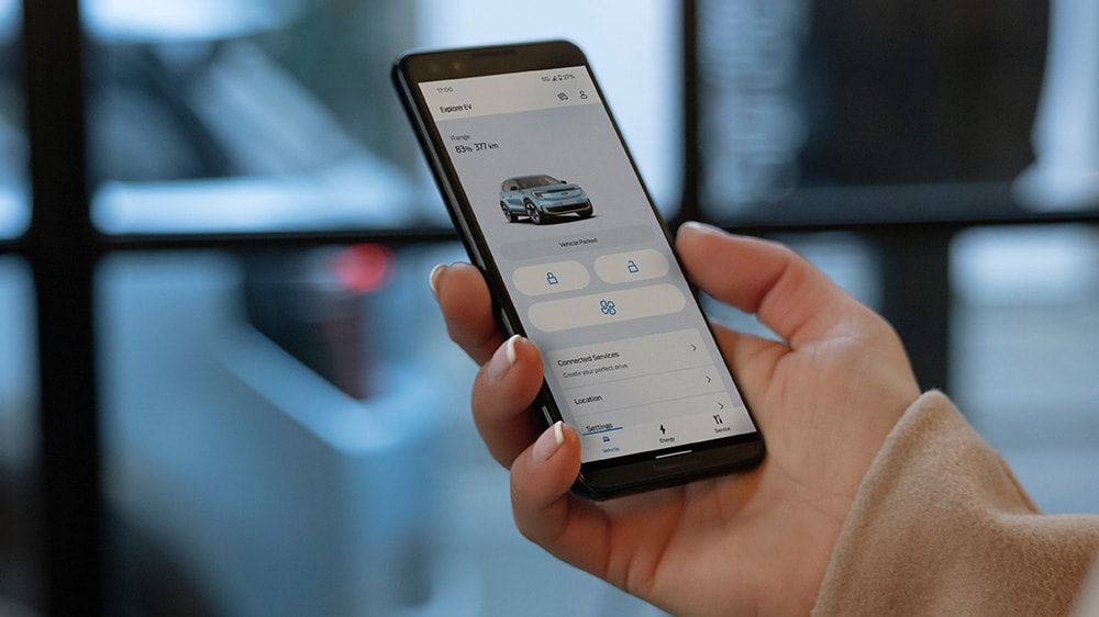 A person looking at the FordPass App. A person looking at the FordPass App.