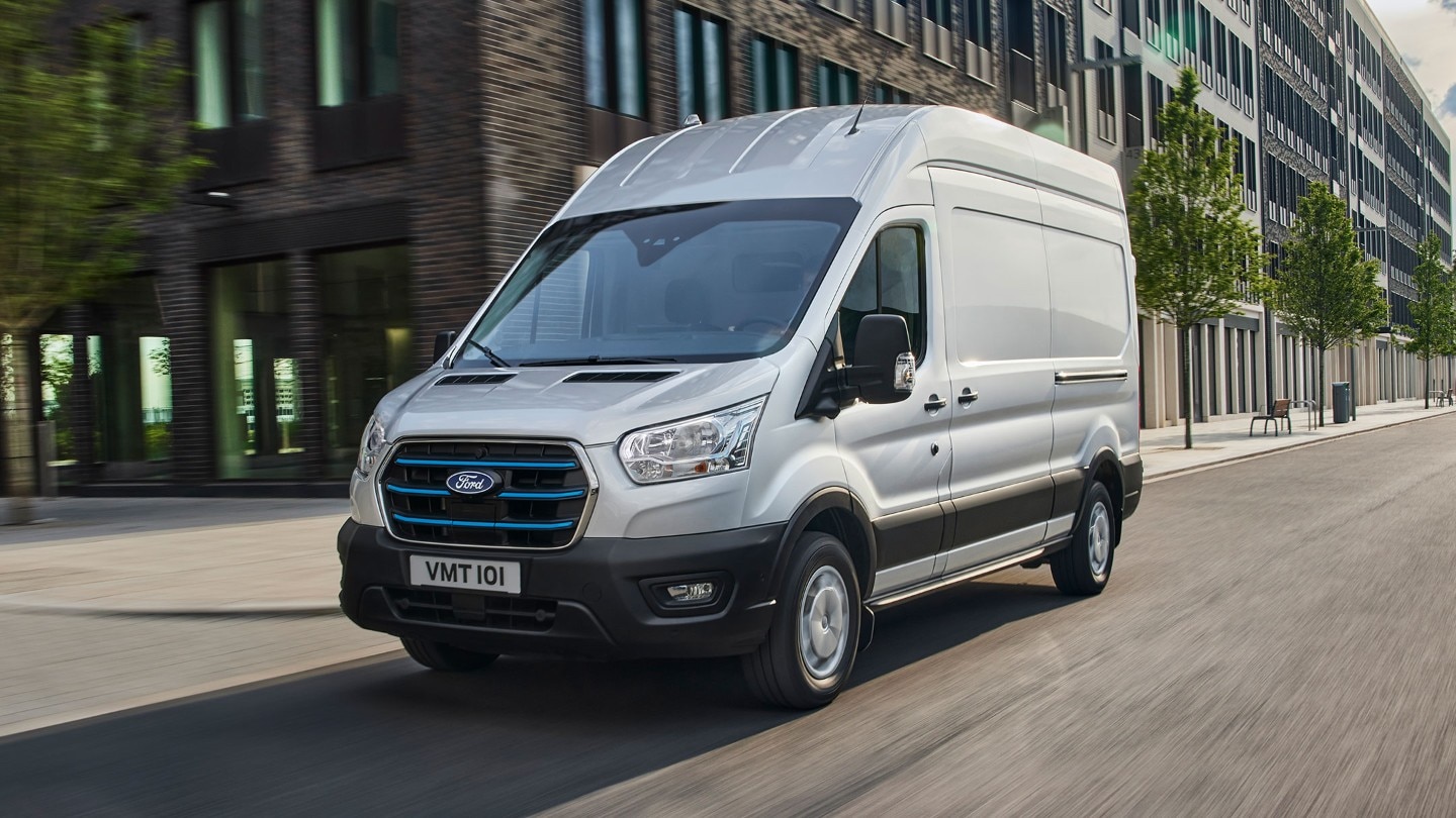 New Ford E-Transit driving through city 3/4 front view