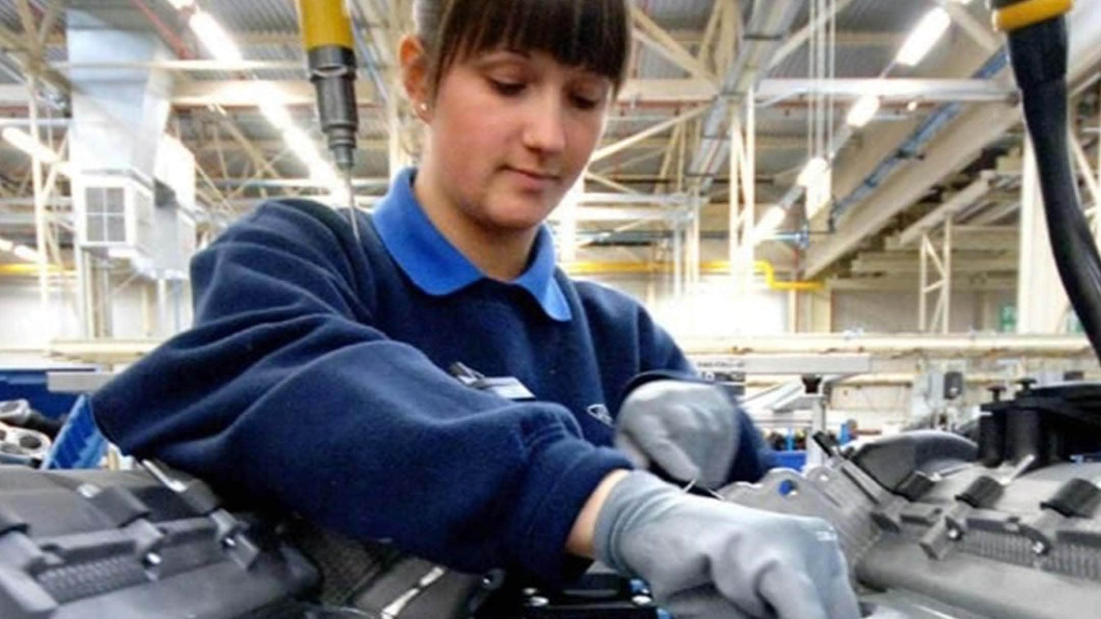 Ford employee working on an engine