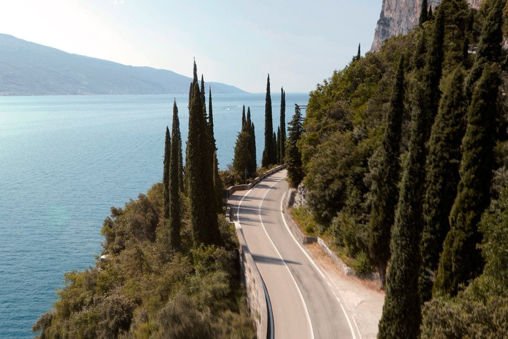 An ariel view of a coastal road and huge expanse of water.