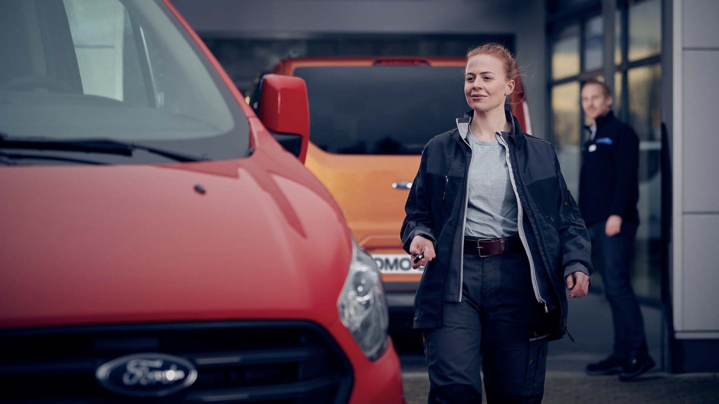 Woman walking towards a red van