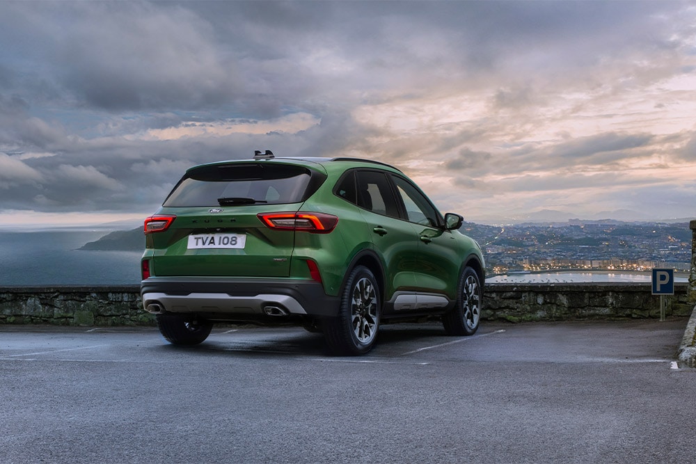 Rear view of a geen Ford Kuga self-charging hybrid car.