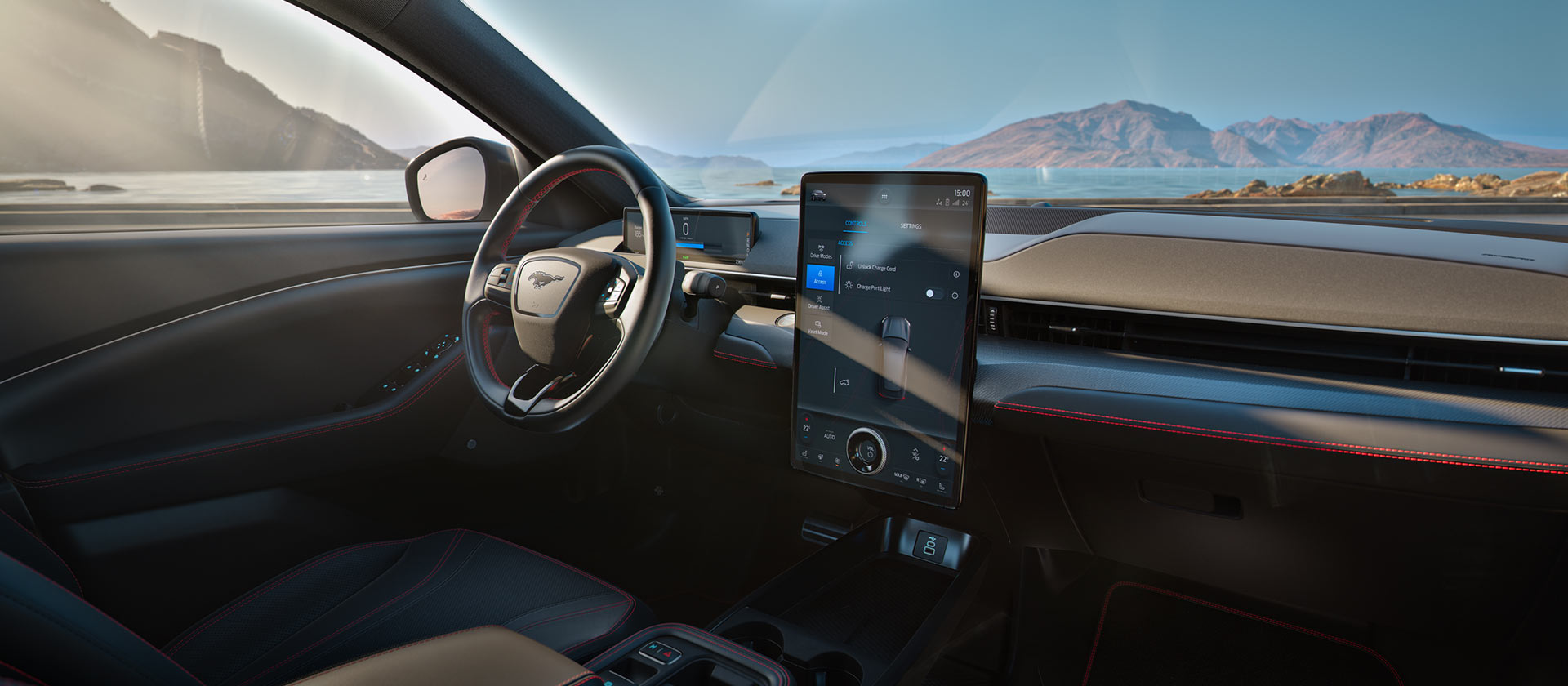 The inside of a Ford EV with its dashboard prominently displayed and mountains in the background.