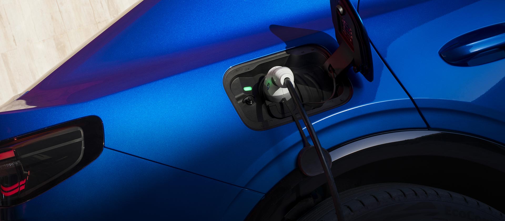 A blue Ford electric car charging.