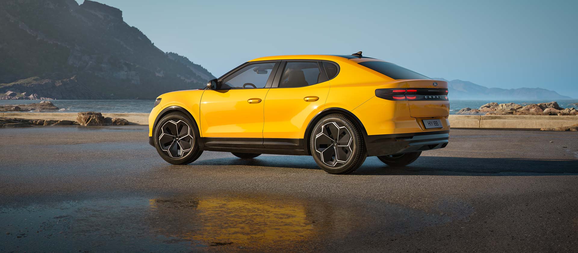 A yellow Ford All-Electric Capri parked next to a beach.