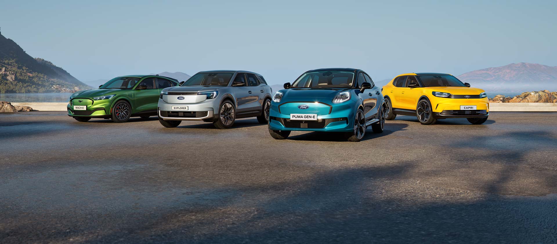 A collection of different Ford electric cars parked on a rugged coastal landscape.