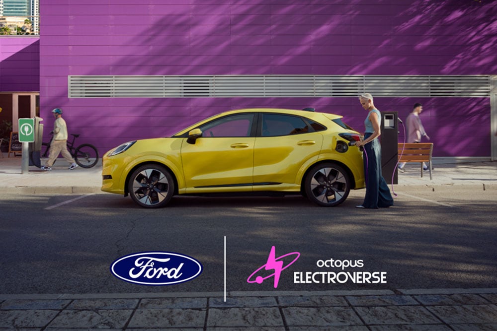 Side view of a yellow electric Ford Puma Gen-E plugged into a public charging point.