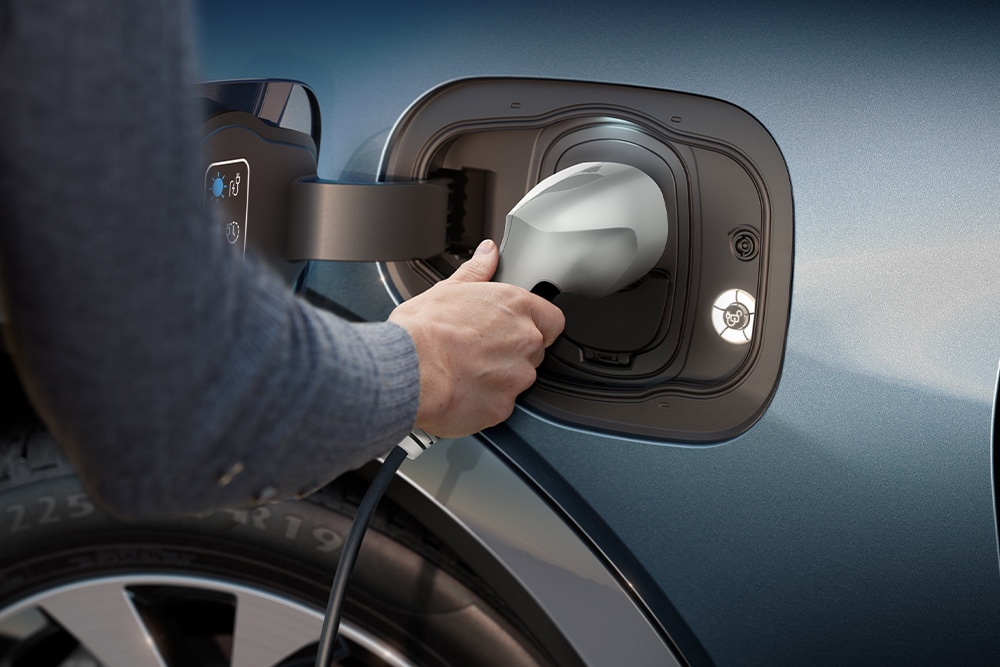 A close up of a person charging a Ford electric vehicle.