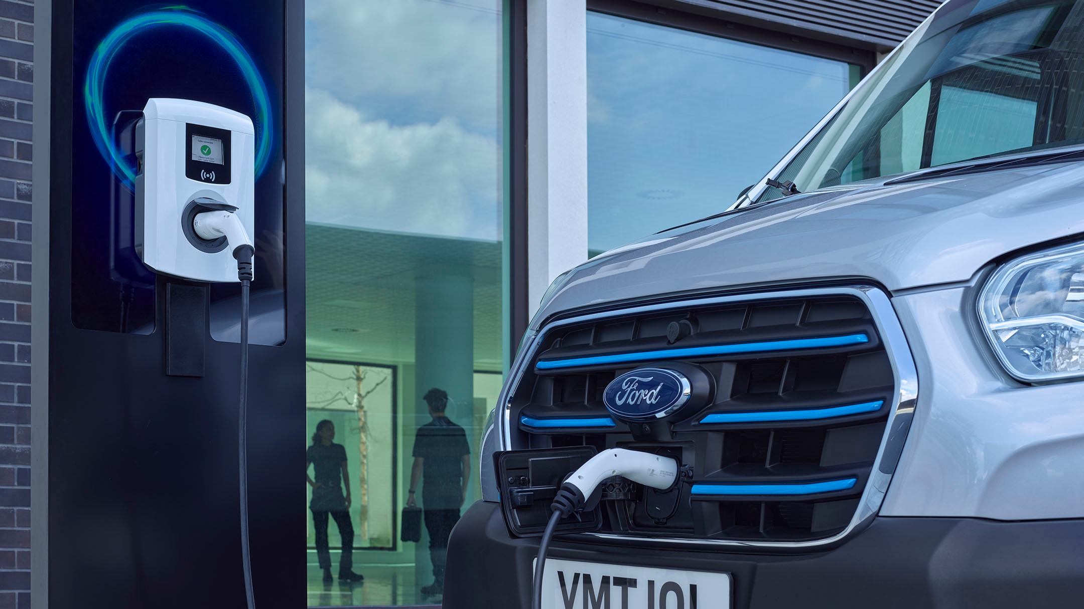 Wall box and Ford Van being charged close up Wall box and Ford Van being charged close up