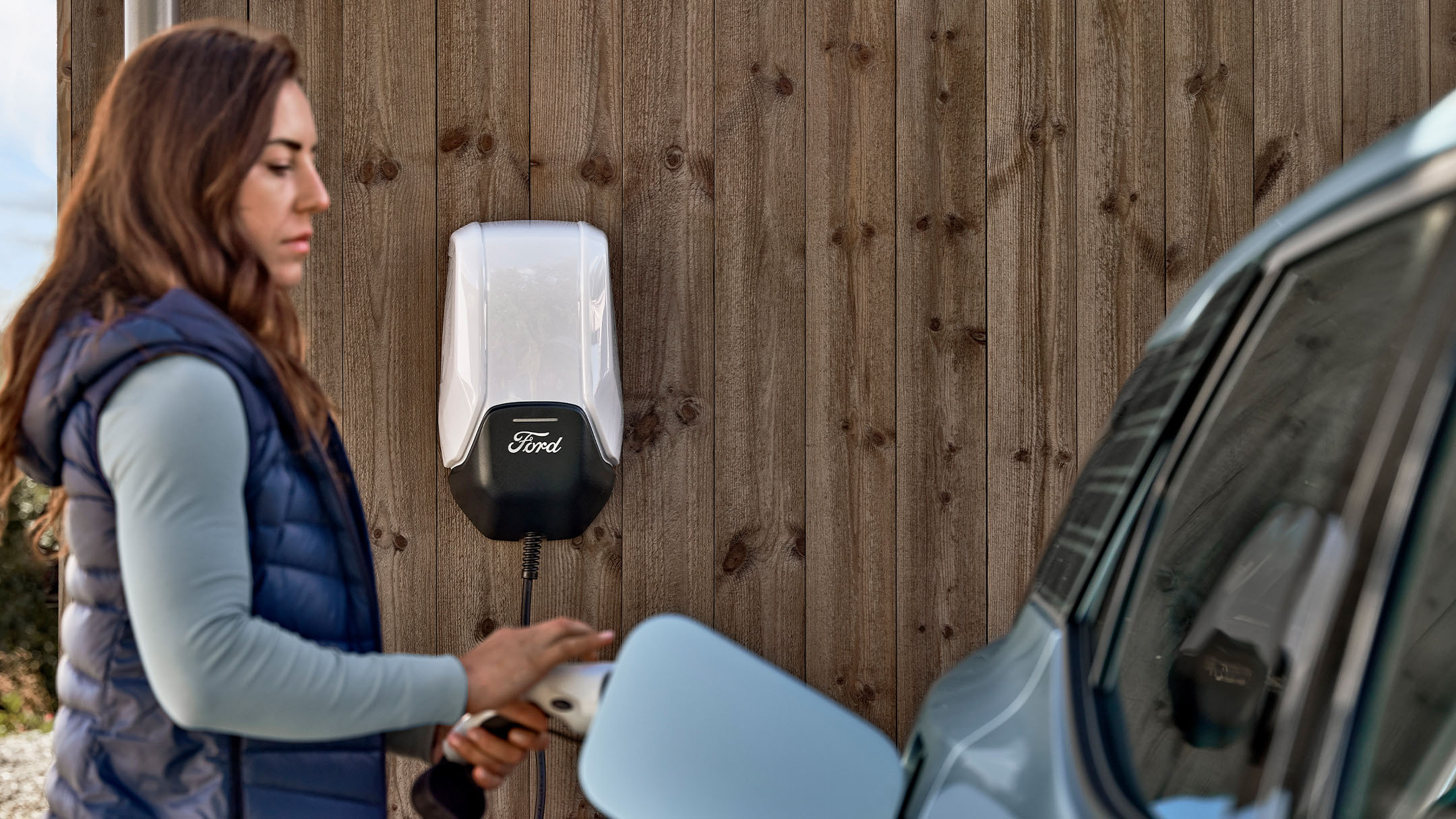 Woman charges an electric car