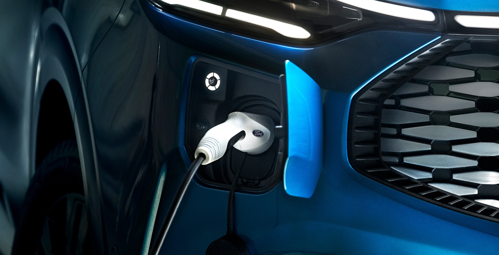 A close up of an electric charging cable plugged into a Ford E-Transit Custom electric van.