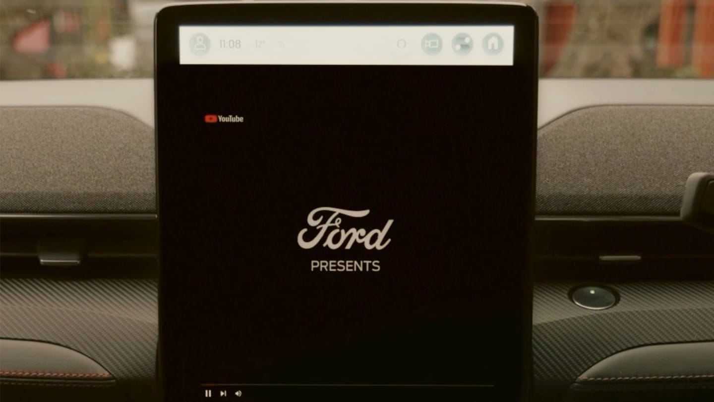 A Ford infotainment screen displaying the Ford logo and "Ford Presents."
