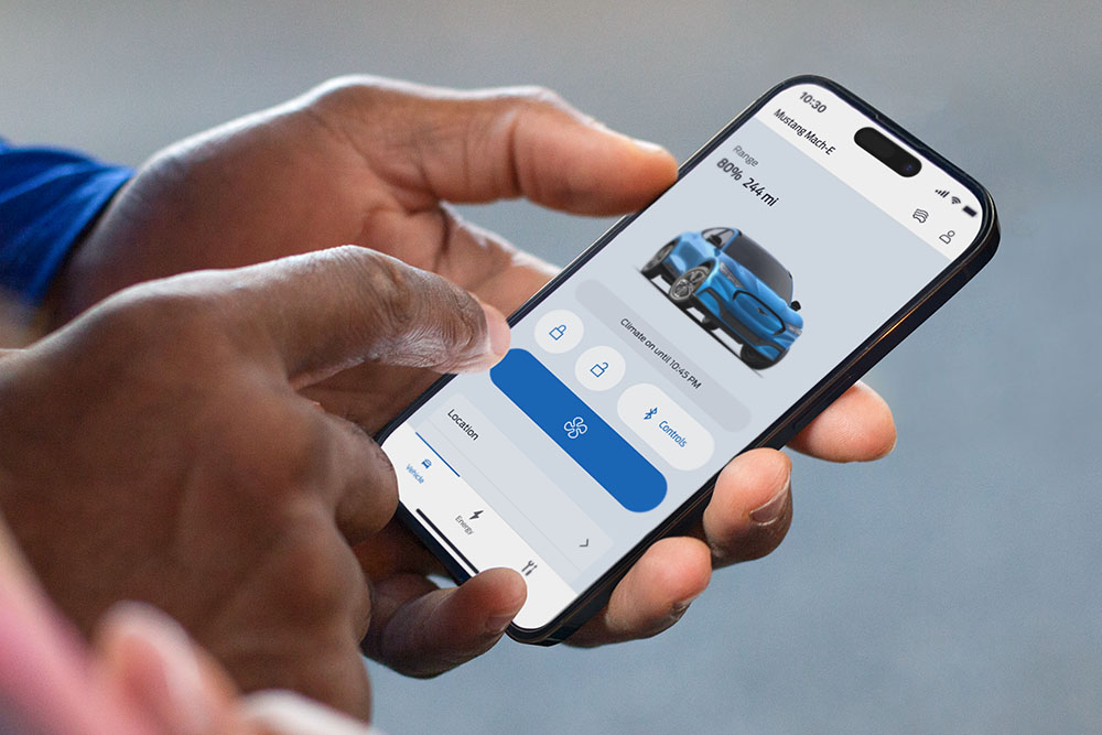 A close-up image of an iPhone showing the FordPass app, with a graphic of a Ford Mustang Mach-E and multiple app buttons.
