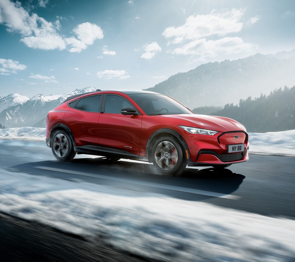All-New Ford Mustang Mach-E driving through snowy mountains