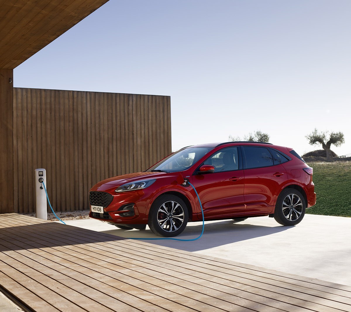 Red All New Ford Kuga parked and charging