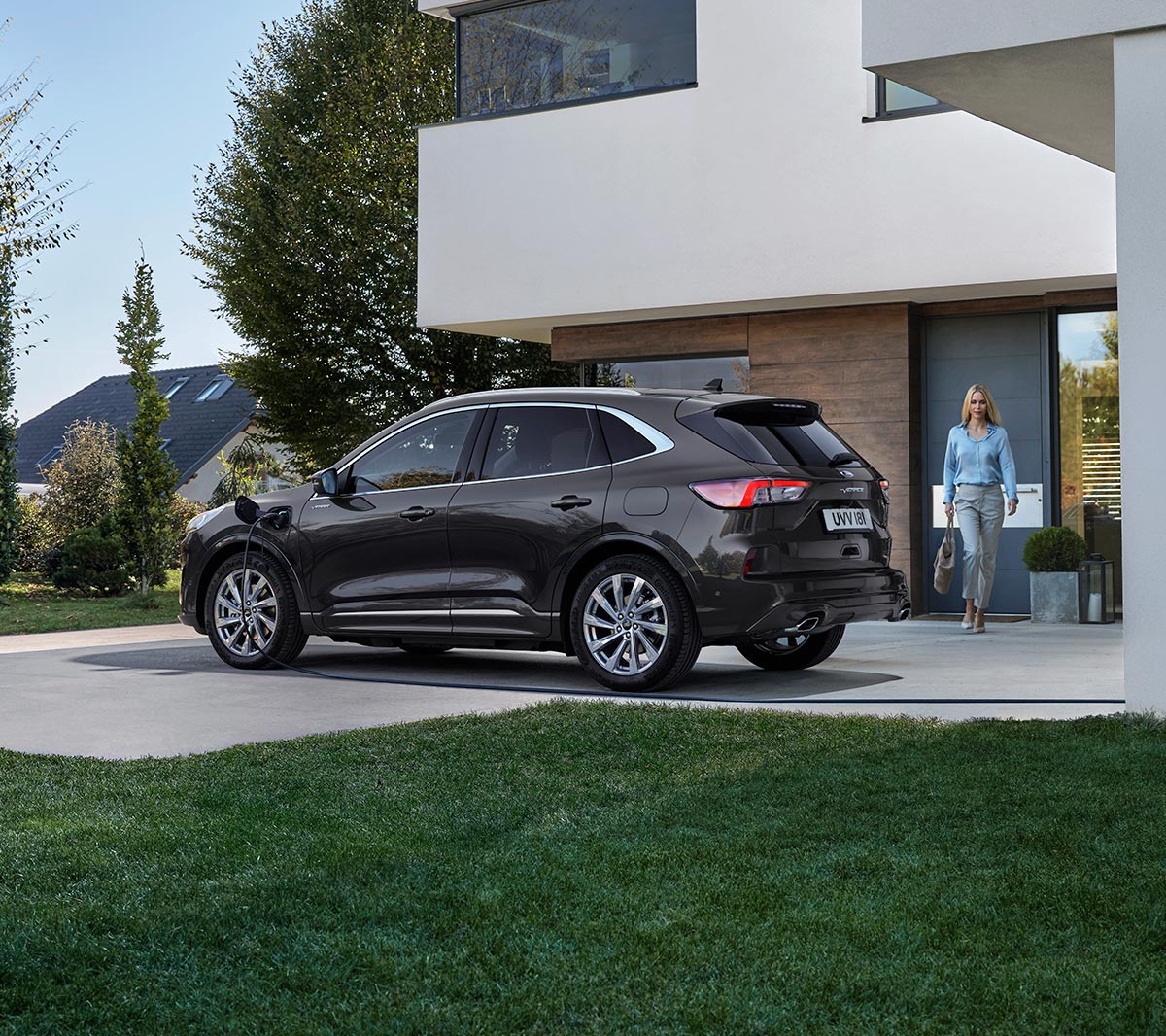 Grey Ford Kuga viewed from back with woman