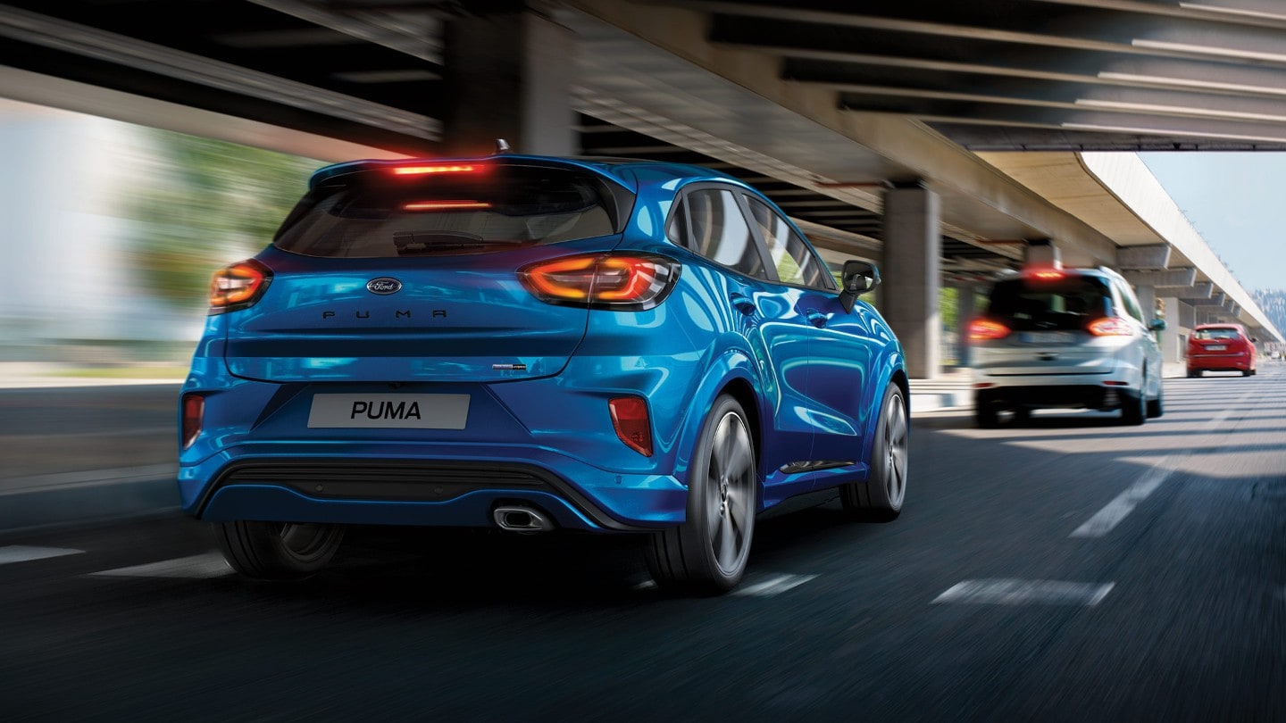 Blue Ford Puma driving in city