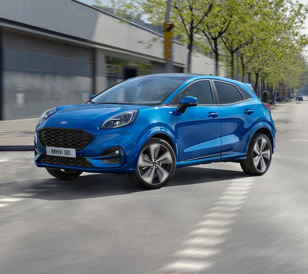 Blue Ford Puma driving in the city