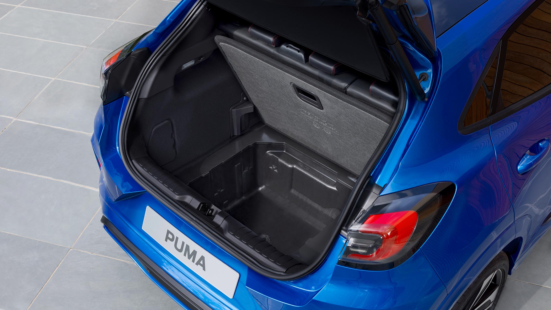Blue  Ford Puma with open booth