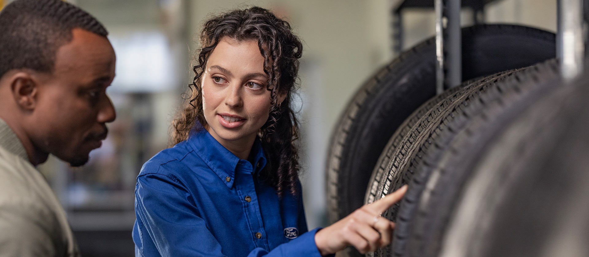 A Ford repairs specialist helping a customer with new Fiesta car tyres