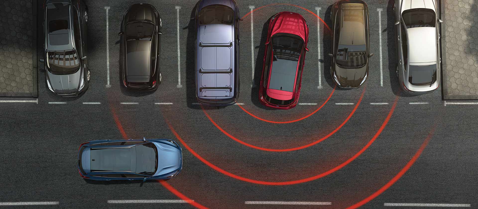A top-down graphic showing a row of parking spaces. Radar lines depict an alert in the reversing red Ford Focus, showing a nearby hazard.