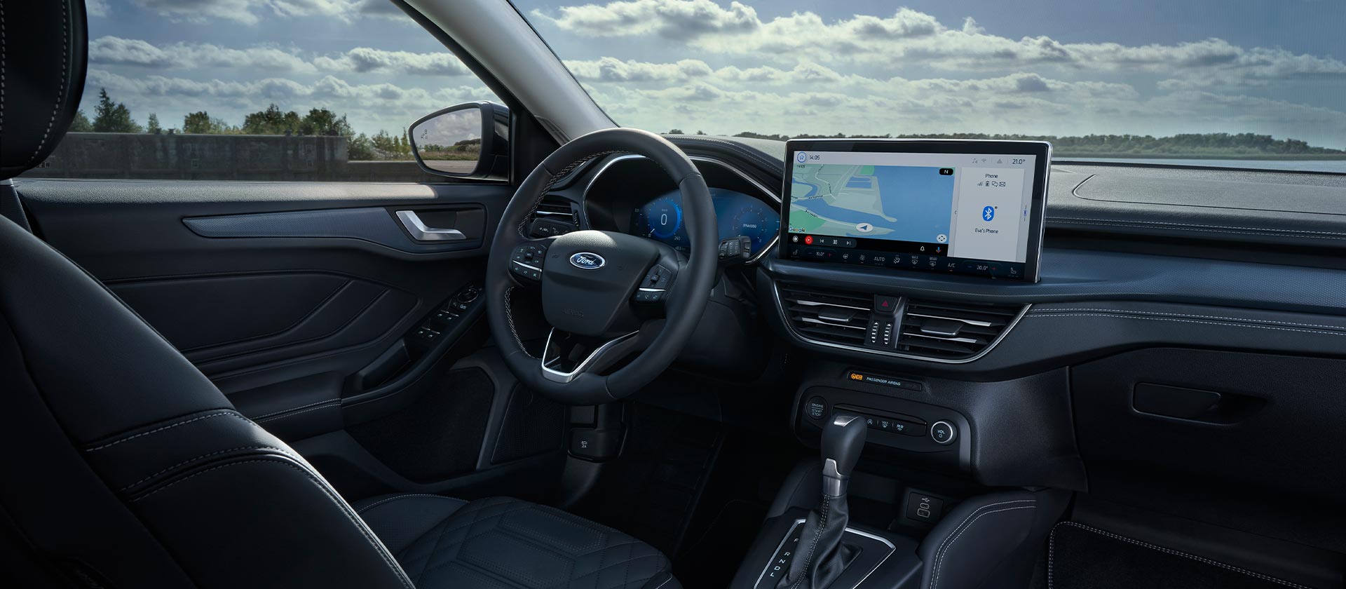 Interior view of the Ford Focus, showing the dashboard, infotainment screen with navigation and steering wheel.