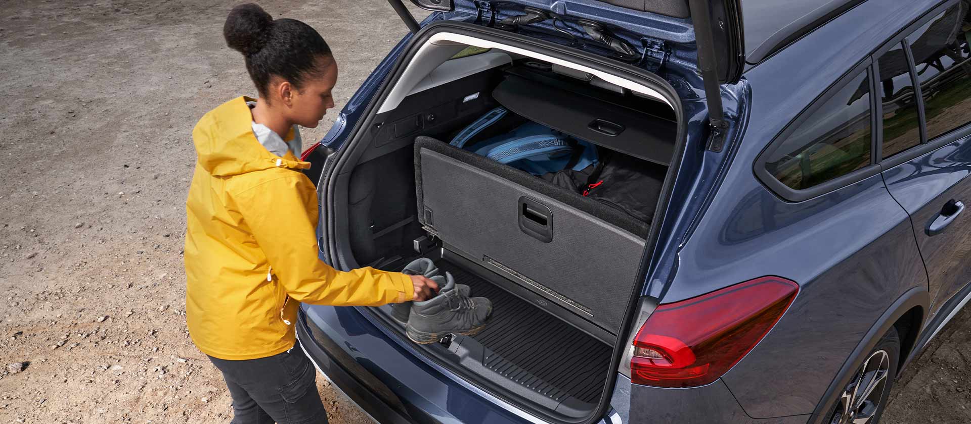 Woman loading shoes into the trunk of a Ford Focus