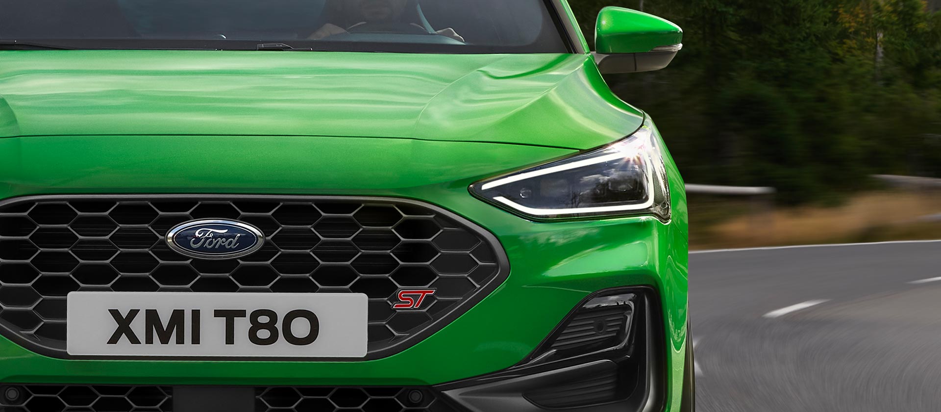 A front view of Mean Green Ford Focus ST, showing the honeycomb grille and ST badge.