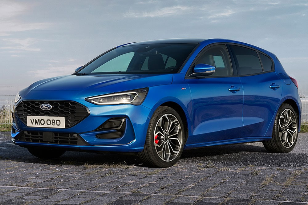 A blue Ford Focus ST-Line hatchback with red brake calipers parked on a paved surface.