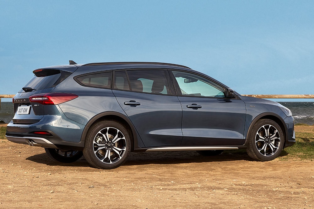 A dark blue Ford Focus Active Estate parked on the sand.