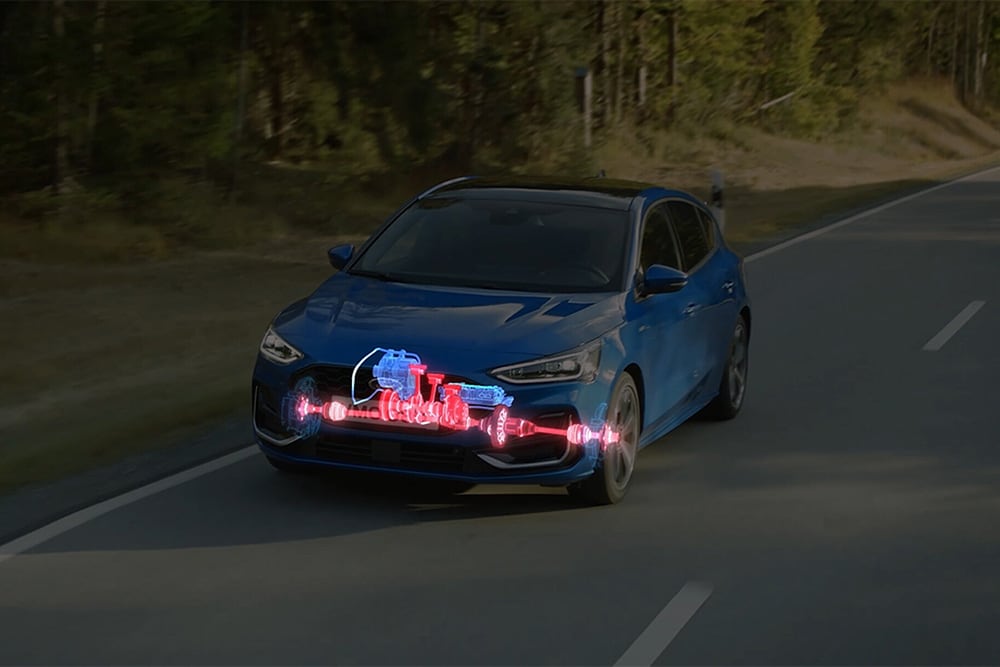 A blue Ford Focus with an illustration showing the EcoBoost Hybrid working in the front of the car.