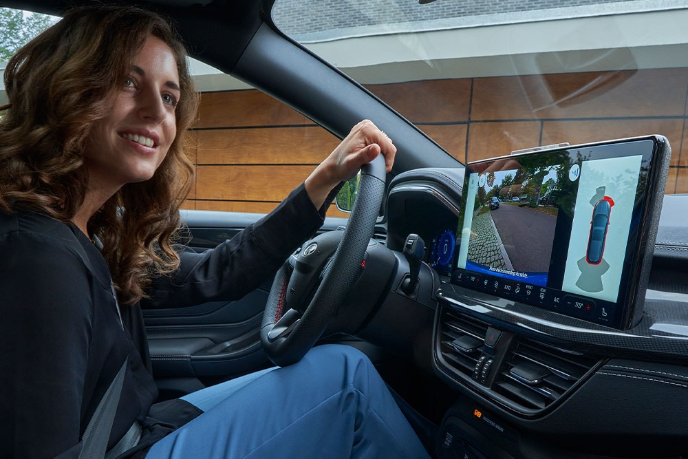 Woman sitting in the driver's seat of a Ford Focus