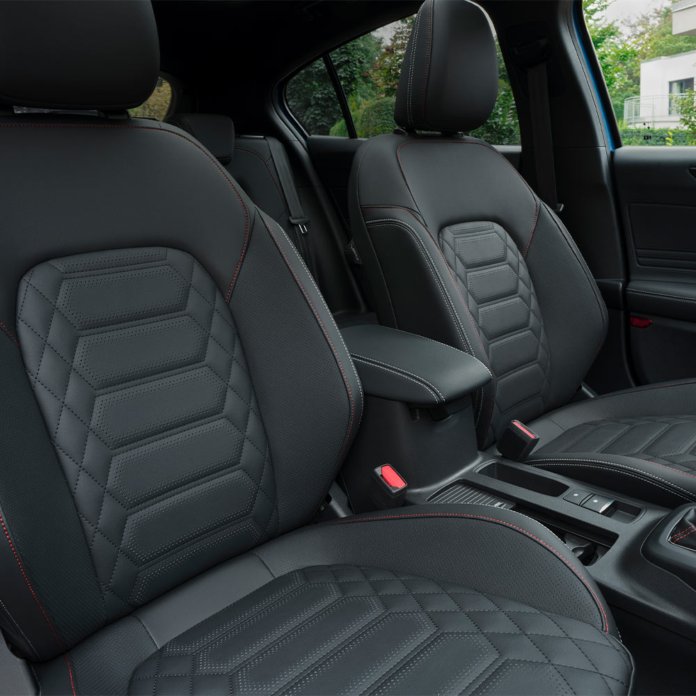 Interior view of the Ford Focus showing black Sensico seats with red stitching.