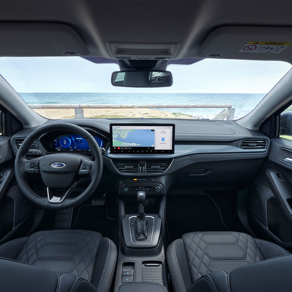 Interior view of the Ford Focus, showing the dashboard, steering wheel and infotainment screen.