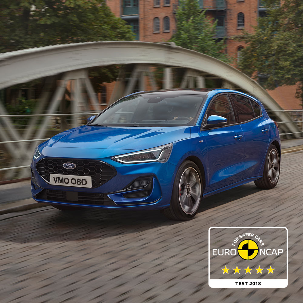 A blue Ford Focus parked on a bridge, with the five-star Euro NCAP safety rating badge in the bottom right corner.