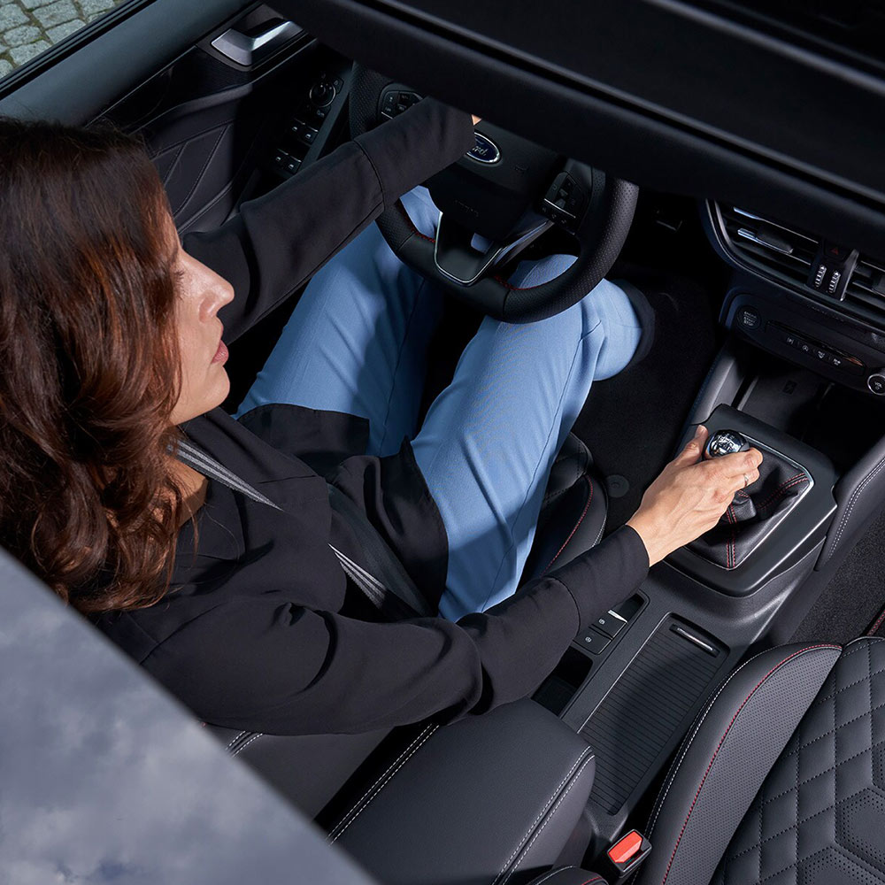 An overhead view of the driver sitting in the Ford Focus, taken through the panoramic glass roof.