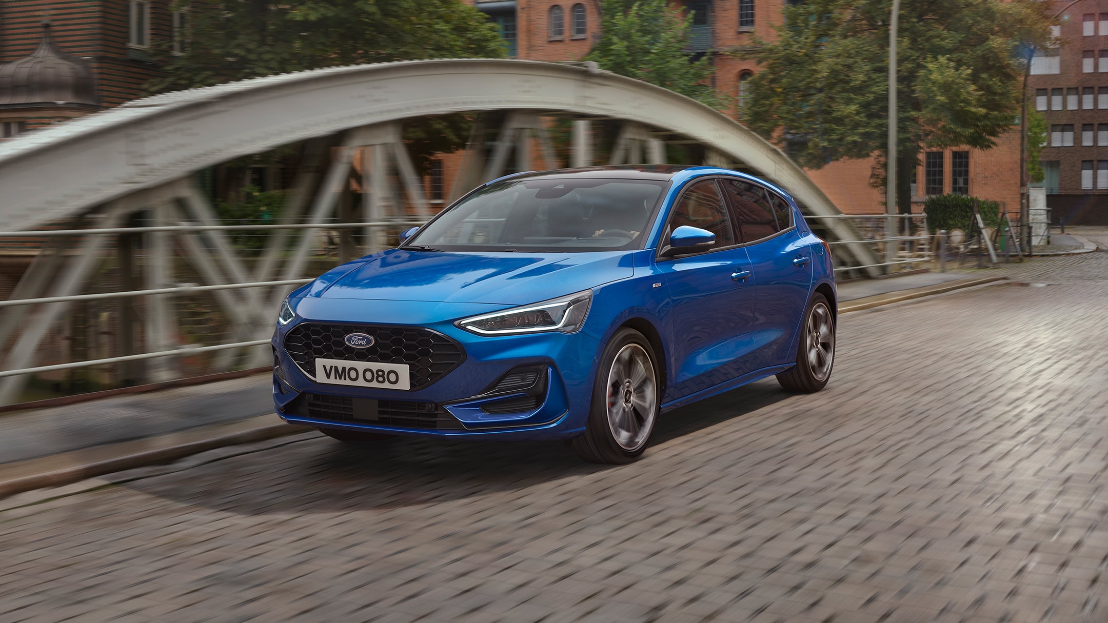 Blue Ford Focus driving on a bridge