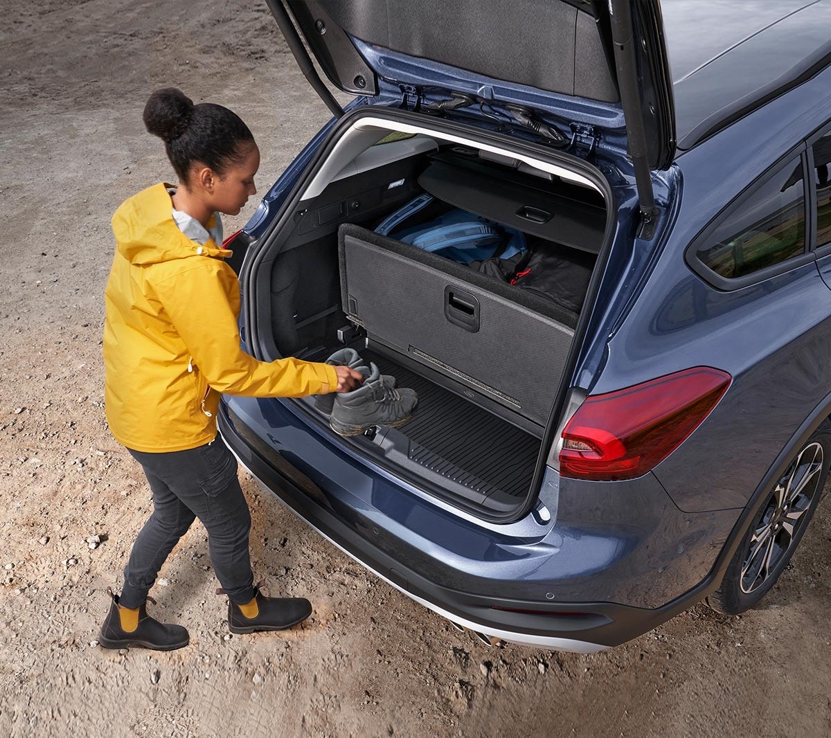 Woman loading a pair of shoes into a Ford Focus