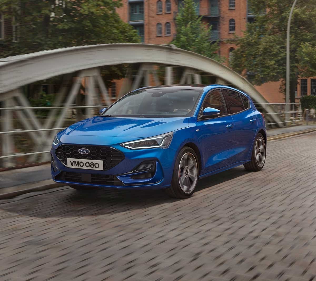 Blue Ford Focus driving on a bridge