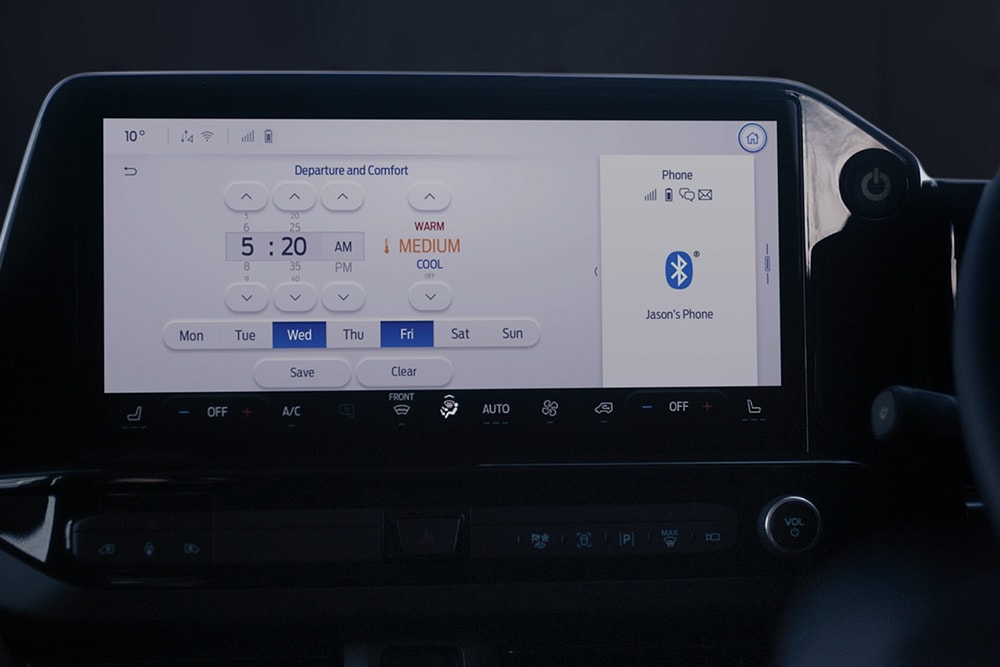 The E-Tourneo Custom's dashboard screen shows the departure and comfort settings, including scheduled pre-conditioning.