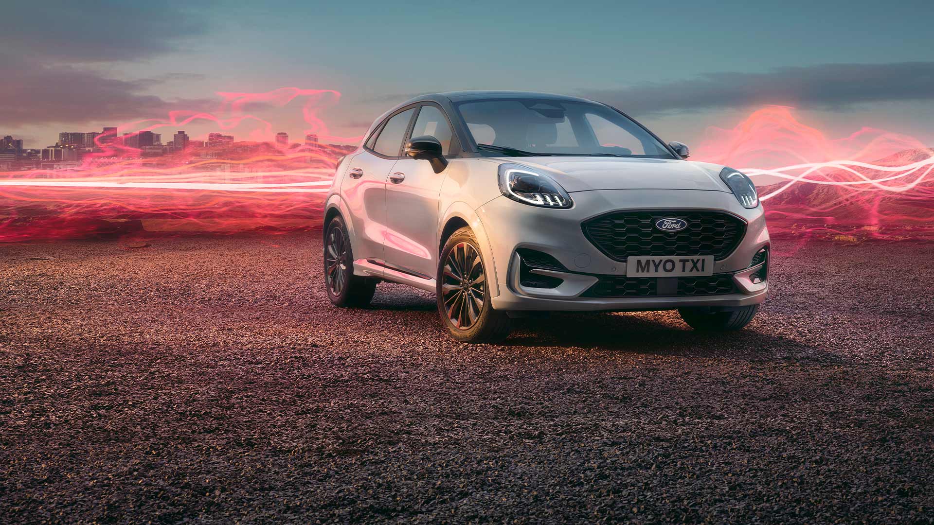 The Ford Puma Sound Edition model in white, parked with red soundwave graphics in the background.