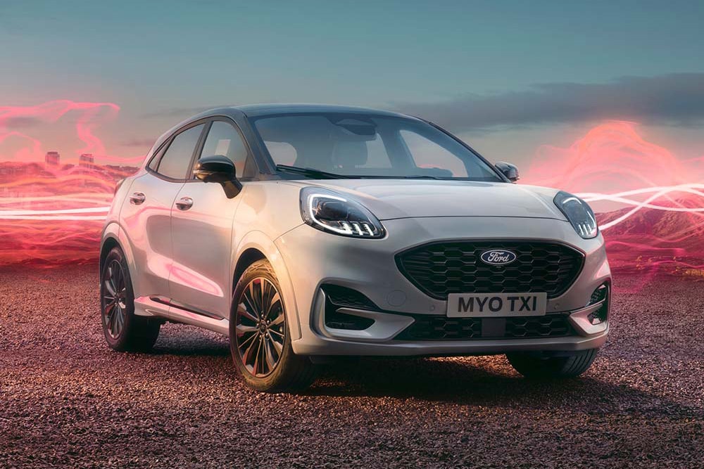 The Ford Puma Sound Edition model in white, parked with red soundwave graphics in the background.
