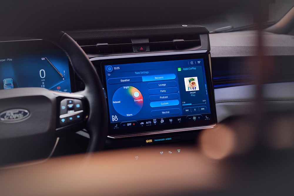 A close up of large touchscreen infotainment system showing the B&O Beosonic feature in the Ford Puma Gen-E Sound Edition.