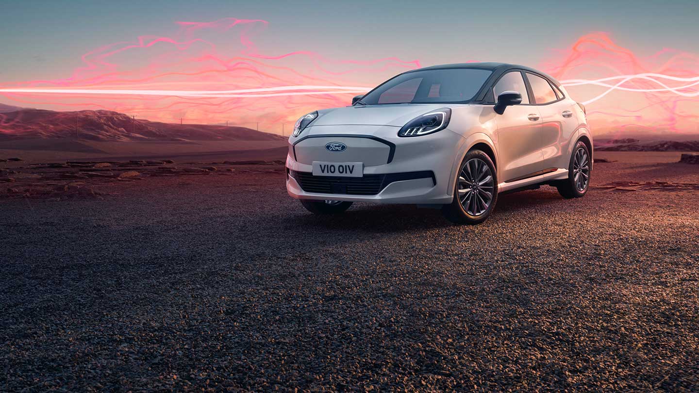 The Ford Puma Gen-E Sound Edition model in white, parked with red soundwave graphics in the background.