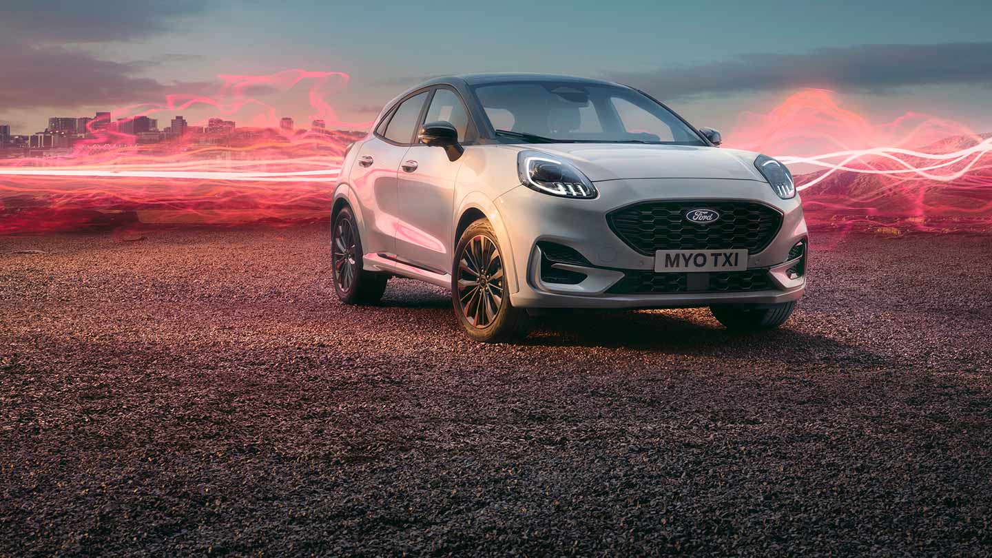 The Ford Puma Sound Edition model in white, parked with red soundwave graphics in the background.