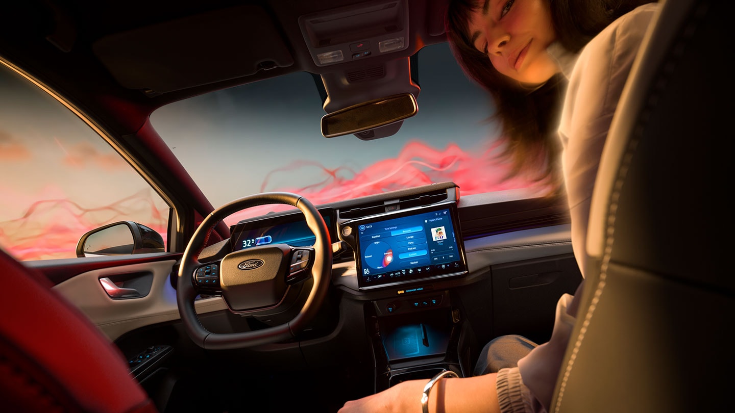 The interior of the Ford Puma Gen-E Sound Edition with a woman sitting in the passenger seat.