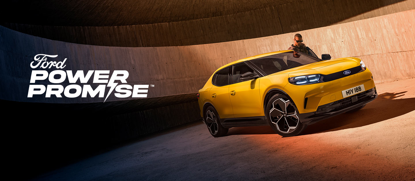 A new yellow Ford Capri® electric SUV parked in a car park.