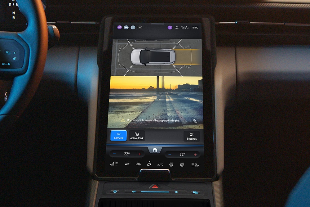 The Ford Capri® touchscreen displaying a split-screen view of the 360° camera system and parking assist guidelines.