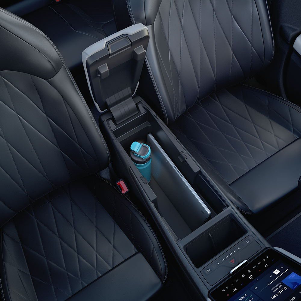 A close-up of a laptop and water bottle inside the MegaConsole in the centre console of the Ford Explorer.