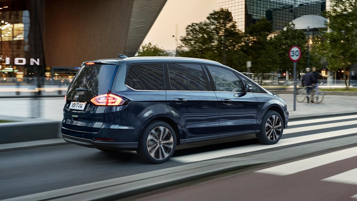 Blue Ford Galaxy in motion with a traffic sign in the background